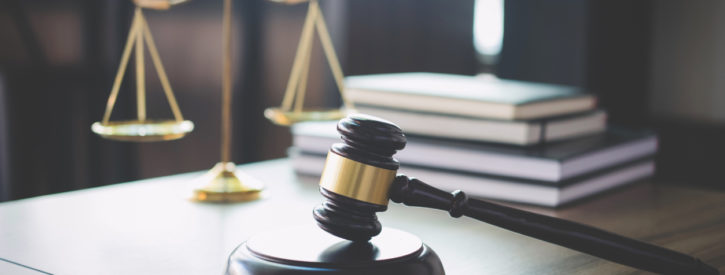 Legal scales of justice and a gavel on a lawyer's desk