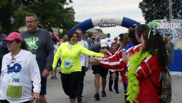 runners giving high fives at race