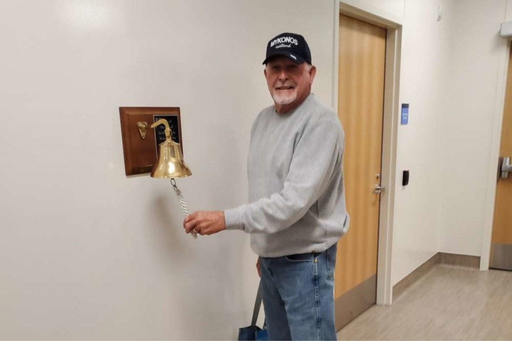 John, a mesothelioma survivor, rings a bell