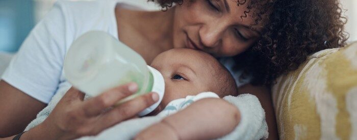 mother feeding her baby formula